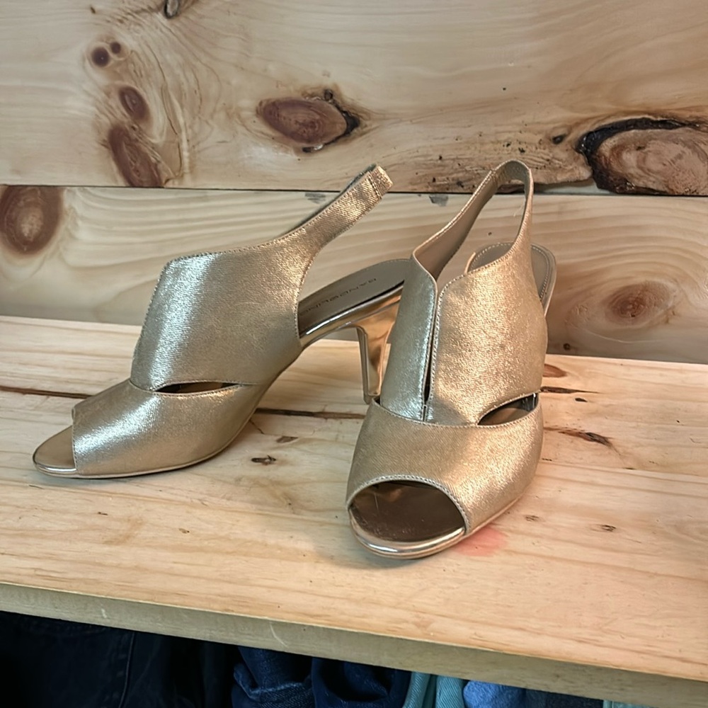 Gold sling back high heel shoes